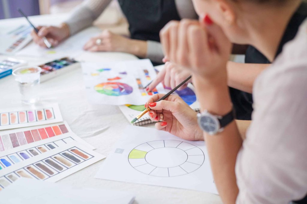 people painting at an art class