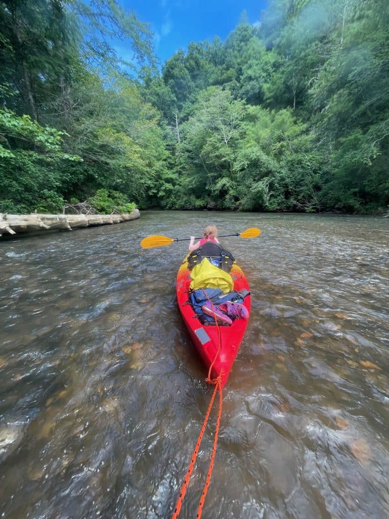 girl in red kayak on a river