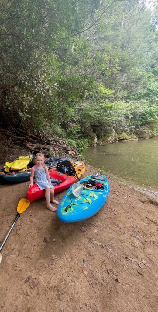 Lydon sitting on her kayak