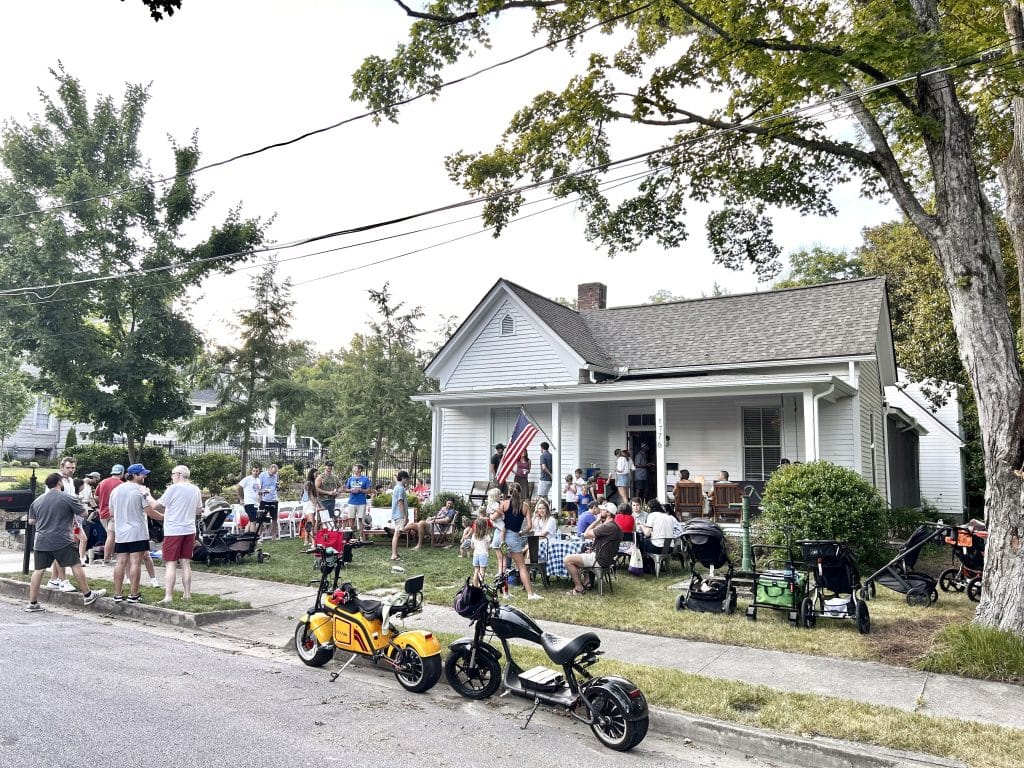 Group of people celebrating July 4th outdoors in a front yard in their community