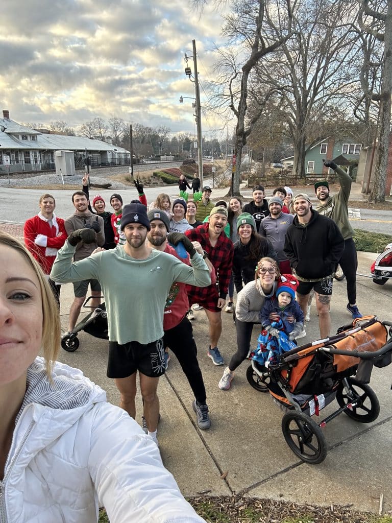 Group of smiling people gathered on the community sidewalk together