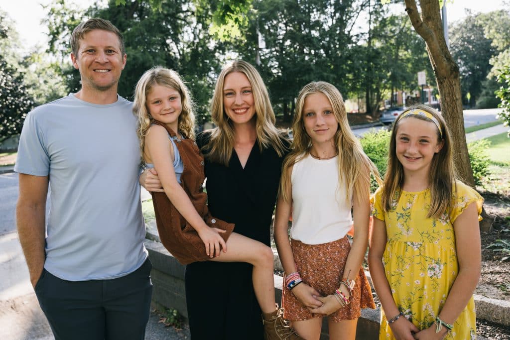 Attractive family of five: mom, dad and three daughters in their community