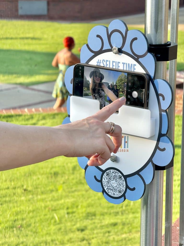 Visitor to downtown Duluth using one of the new selfie stands to take a photo