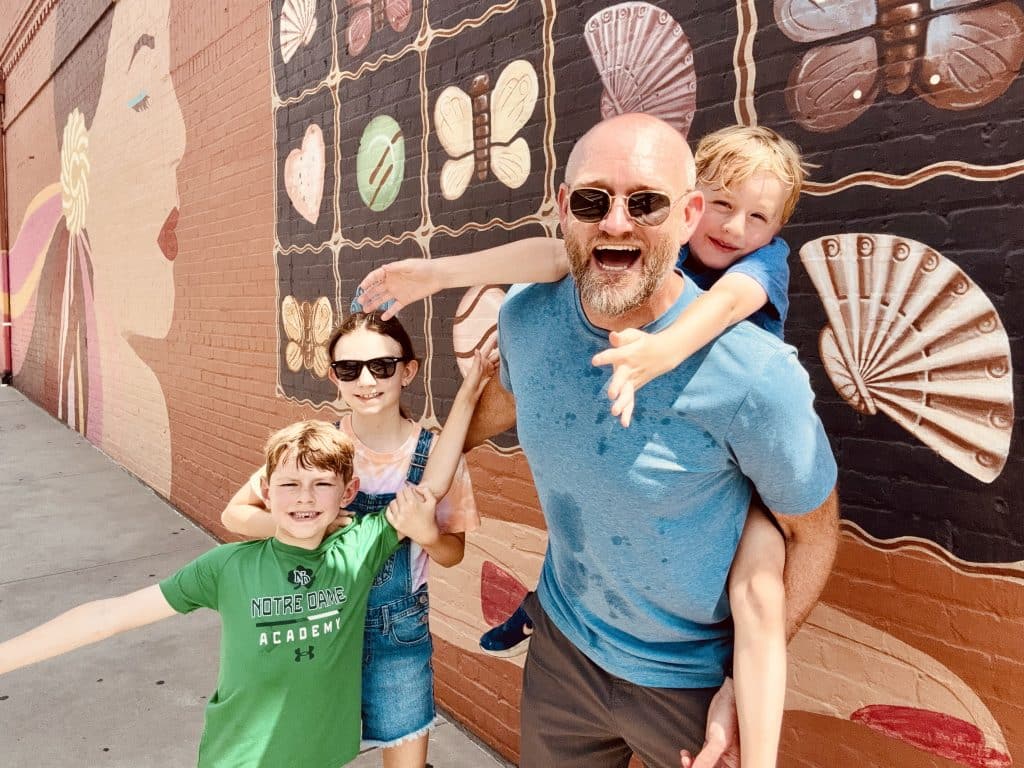 Happy family in front of mural in downtown Duluth