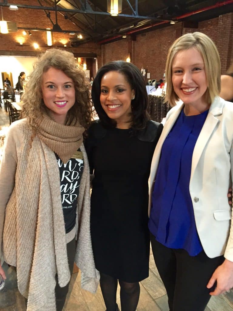 Three women on set of the Today Show looking and smiling at the camera