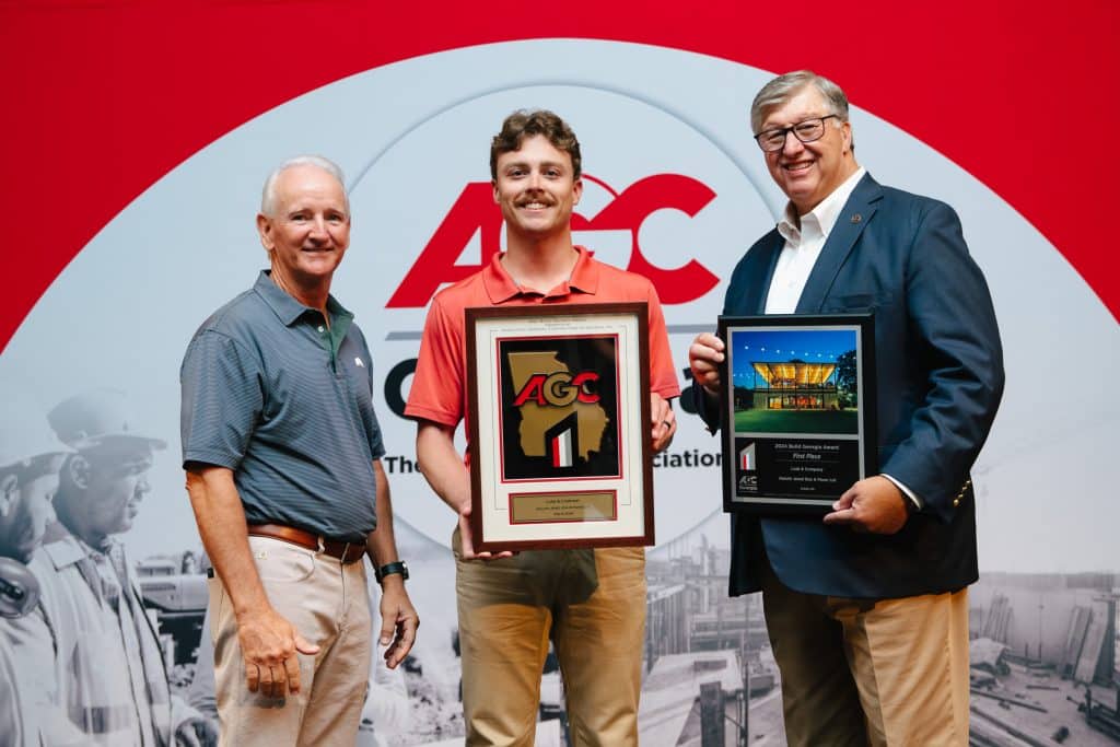 Three men giving/receiving an award