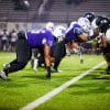 high school football players on field during game