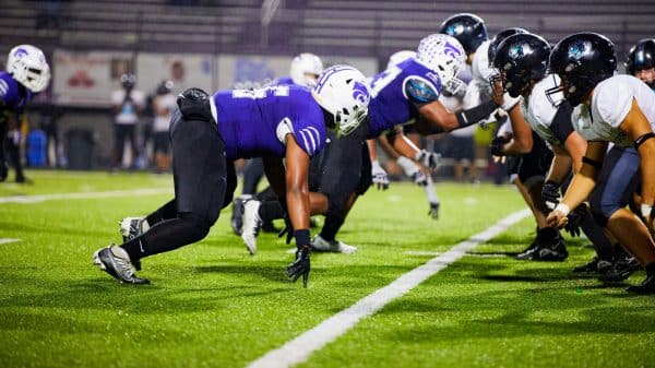 high school football players on field during game