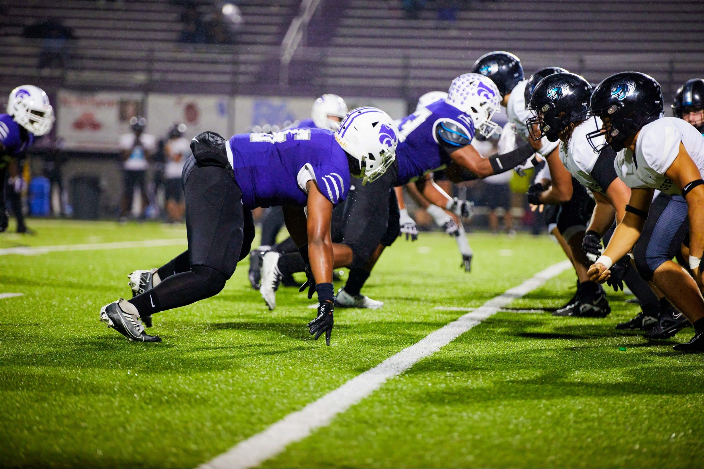 high school football players on field during game