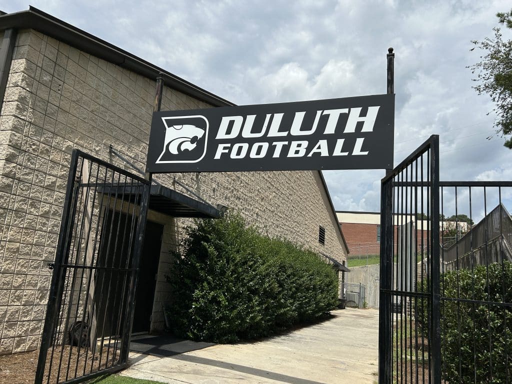 high school football sign leading to building