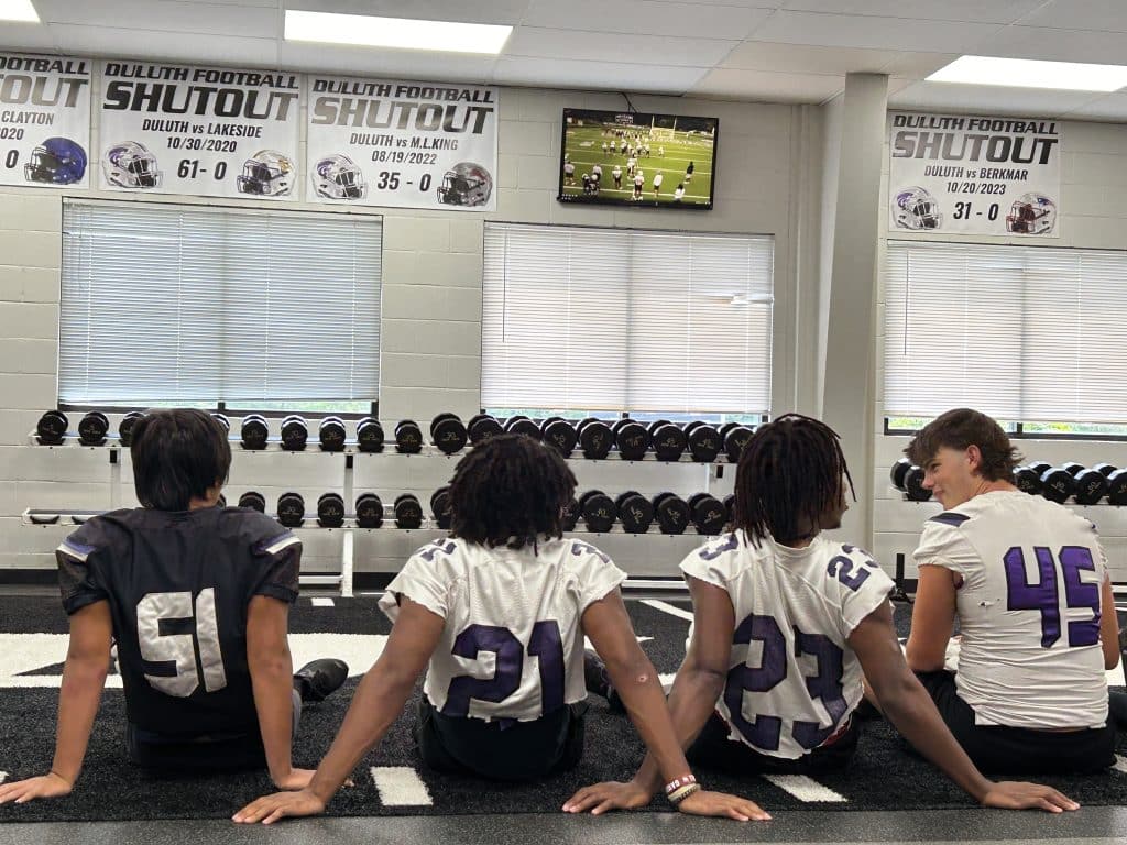 football players in training room