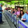 people riding on a small train