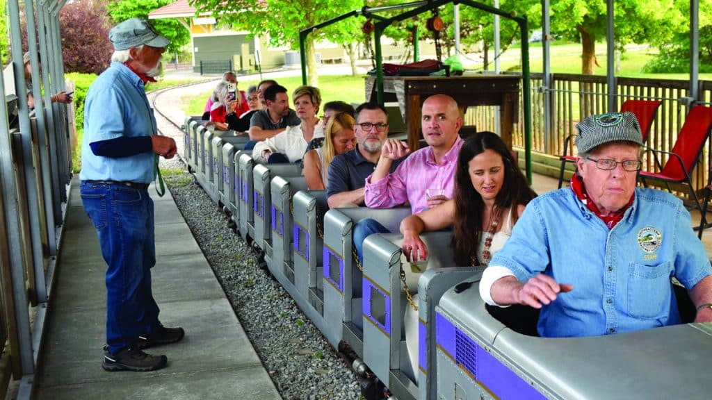 people riding on a small train