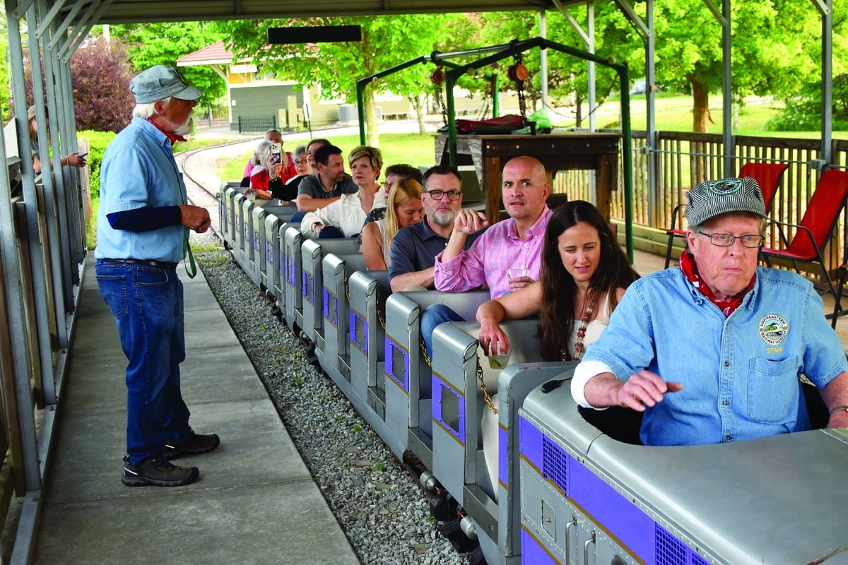 people riding on a small train