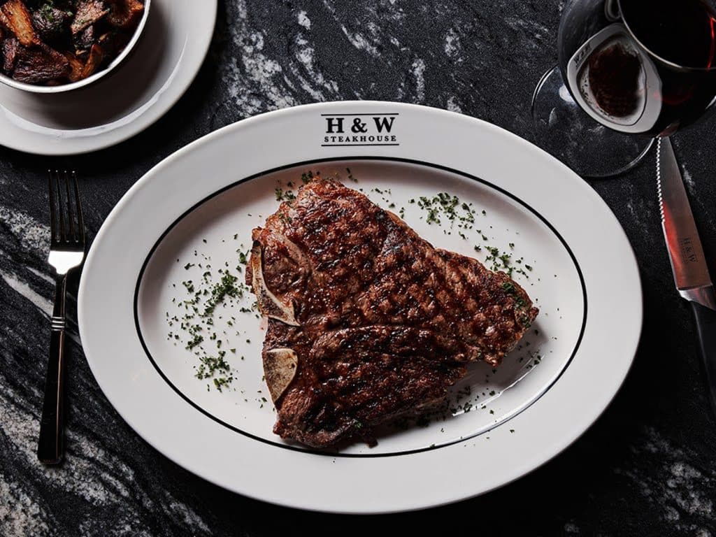 steak on a white plate at a fancy restaurant