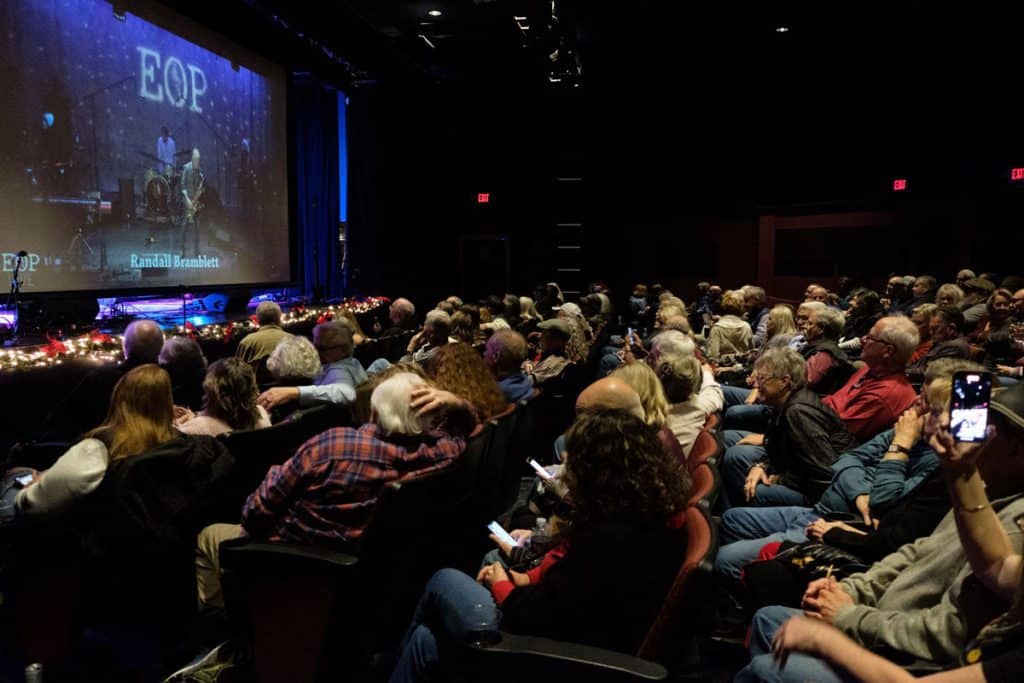 an audience at a music show in a small theater