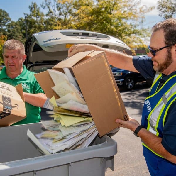 Two people recycling paper