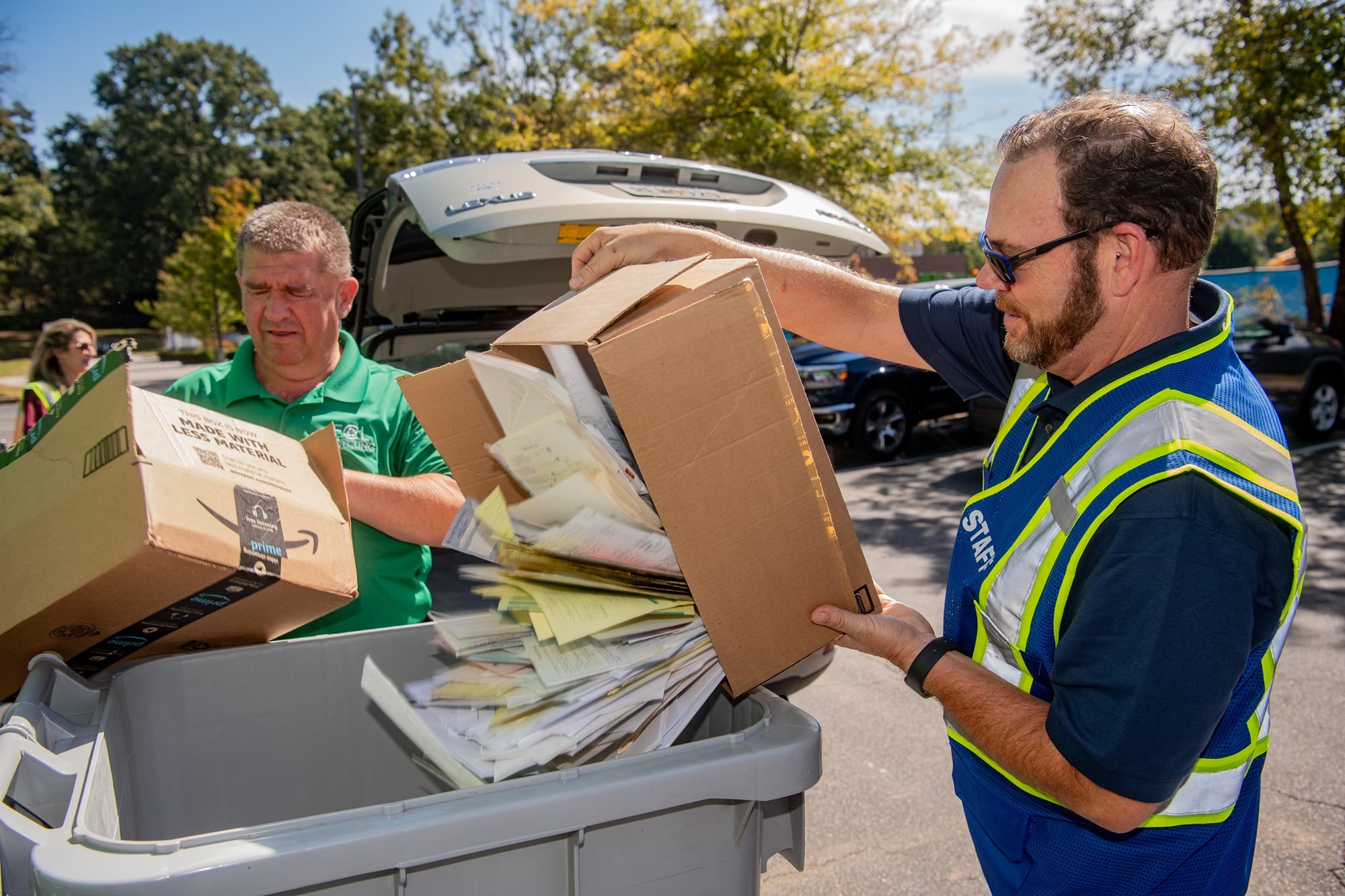 Two people recycling paper