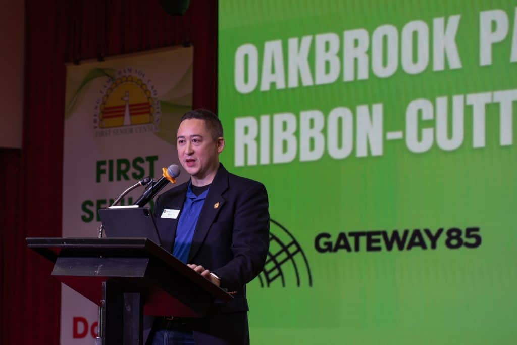 man speaking at a ribbon-cutting ceremony