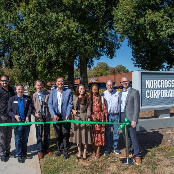 Group of people standing outside at a ribbon-cutting ceremony for the completion of the Oakbrook Parkway sidewalk project