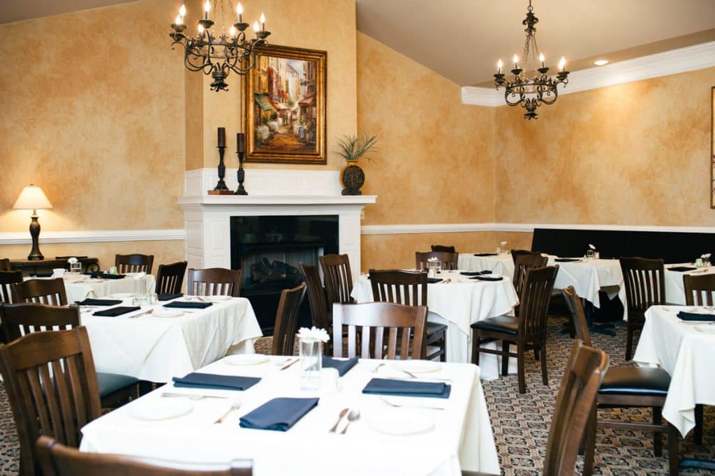 dining room with tables covered in white table cloths