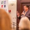 Man speaking in front of an audience at a Southwest Gwinnett Chamber of Commerce meeting