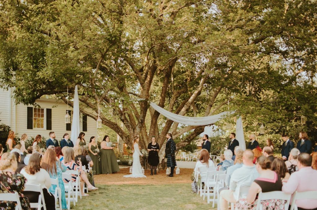 Wedding ceremony beneath a large tree