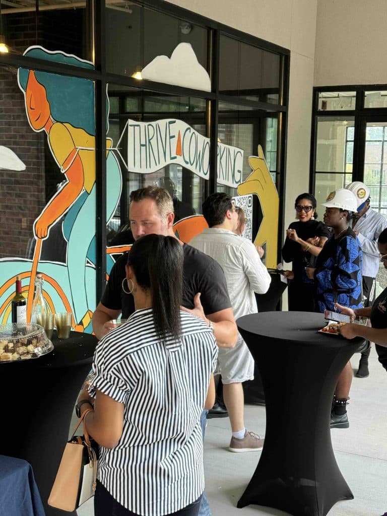 People mingling at an afternoon grand opening party for a local business