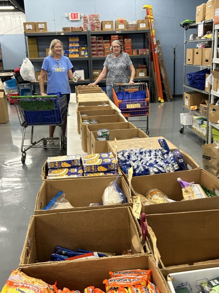 volunteers at a well-organized food pantry