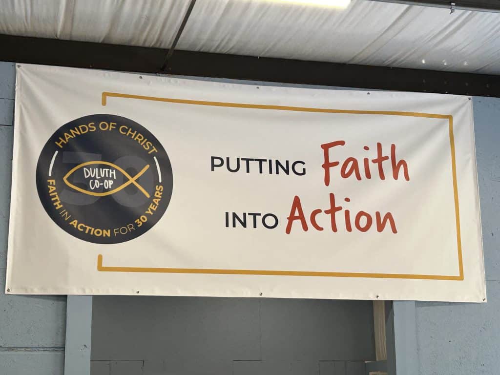 Putting faith into action banner at the Duluth Co-op