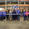 Group of people in a warehouse building at a ribbon cutting ceremony