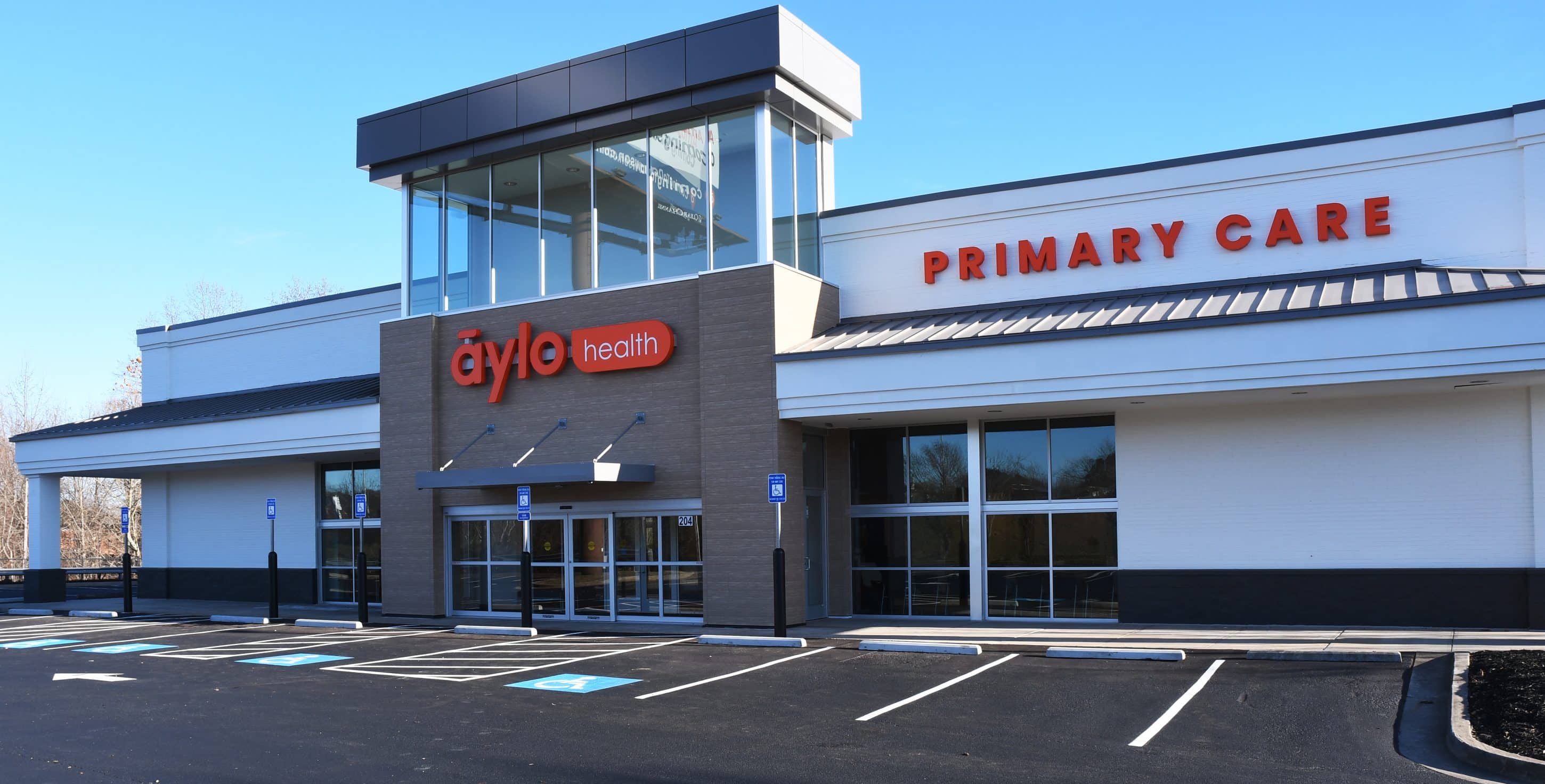 Exterior shot of an Aylo Healthcare Center and empty parking lot.