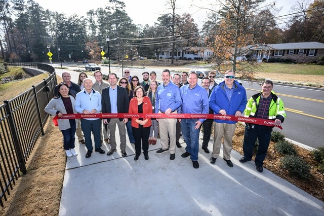 Outdoor ribbon cutting ceremony with a group of people in Dunwoody, GA