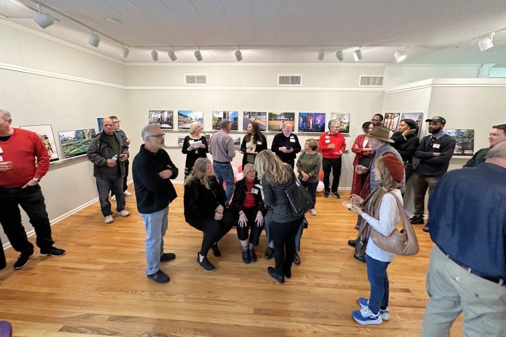 Group of people at a photo exhibit reception