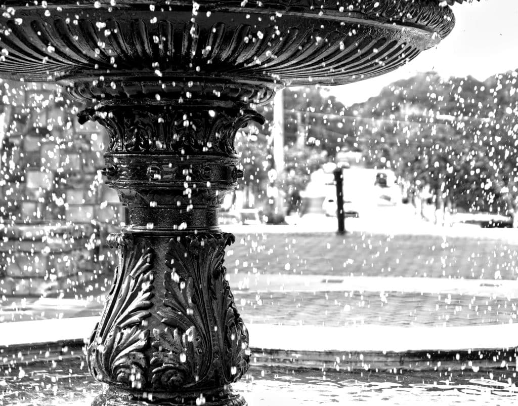 Up close black and white photo of a fountain in a Norcross park