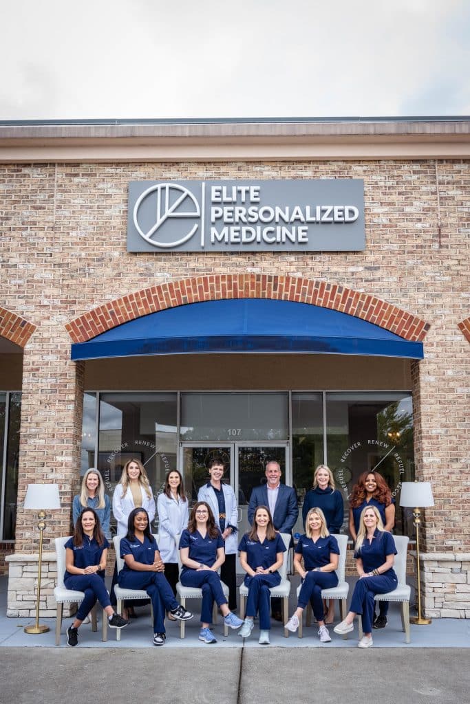 The staff at Elite Personalized Medicine posing together in front of their facility in Peachtree Corners.