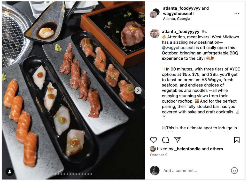 Plates of sushi served on narrow black platters alongside meat and a small tabletop grill at Wagyu House Atlanta.