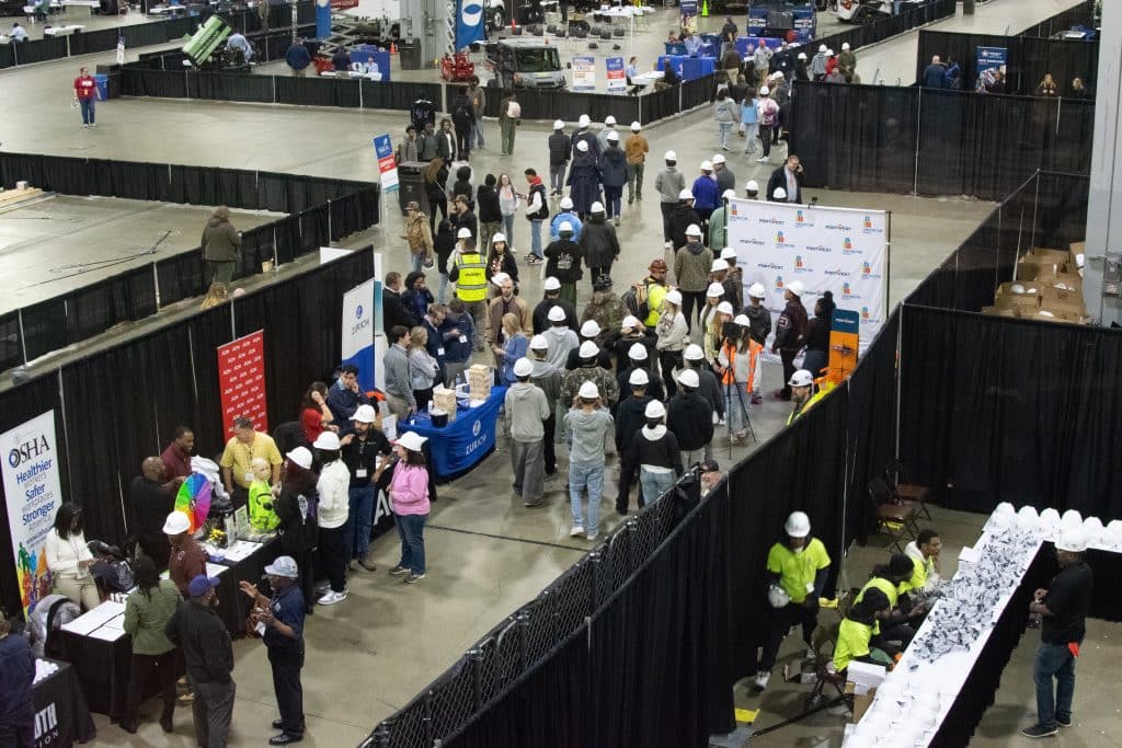 Aerial shot of groups of people wearing white hardhats at a Construction Ready CareerEXPO event in Atlanta.