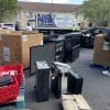 Electronics recycling event with boxes and electronics items filling up a parking lot.