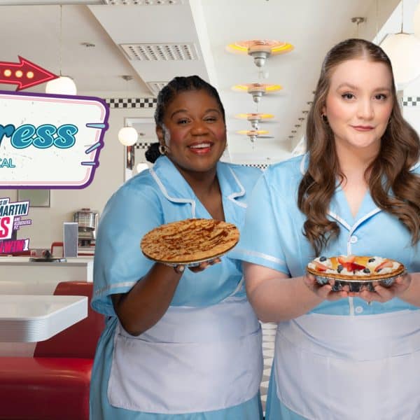 Three actresses in character, wearing light blue diner waitress costumes with white aprons and holding pies. They are promoting Waitress the Musical at Aurora Theatre.