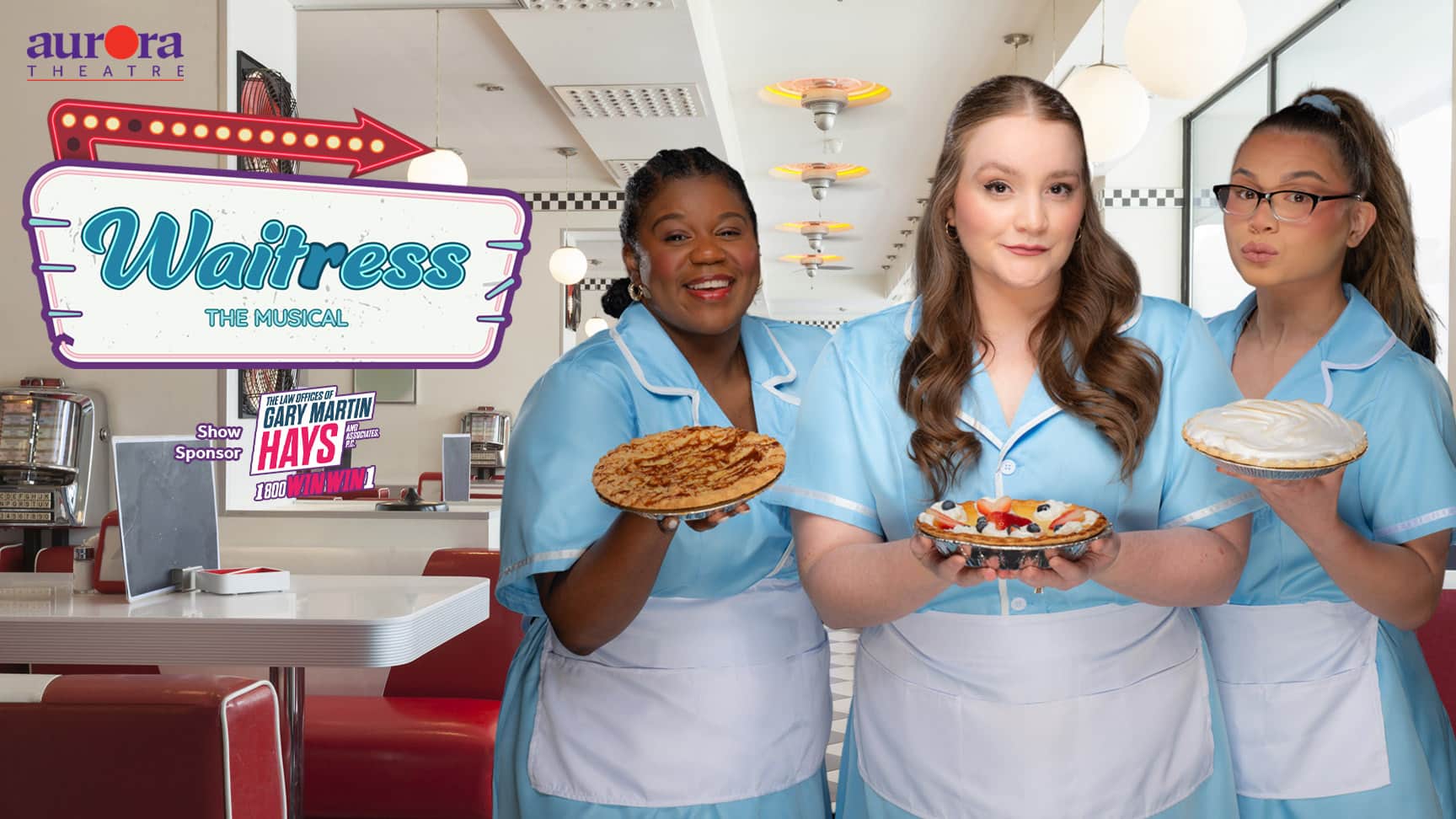 Three actresses in character, wearing light blue diner waitress costumes with white aprons and holding pies. They are promoting Waitress the Musical at Aurora Theatre.