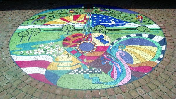 A large colorful mosaic on a paved surface at Thrasher Park in Norcross, Georgia.