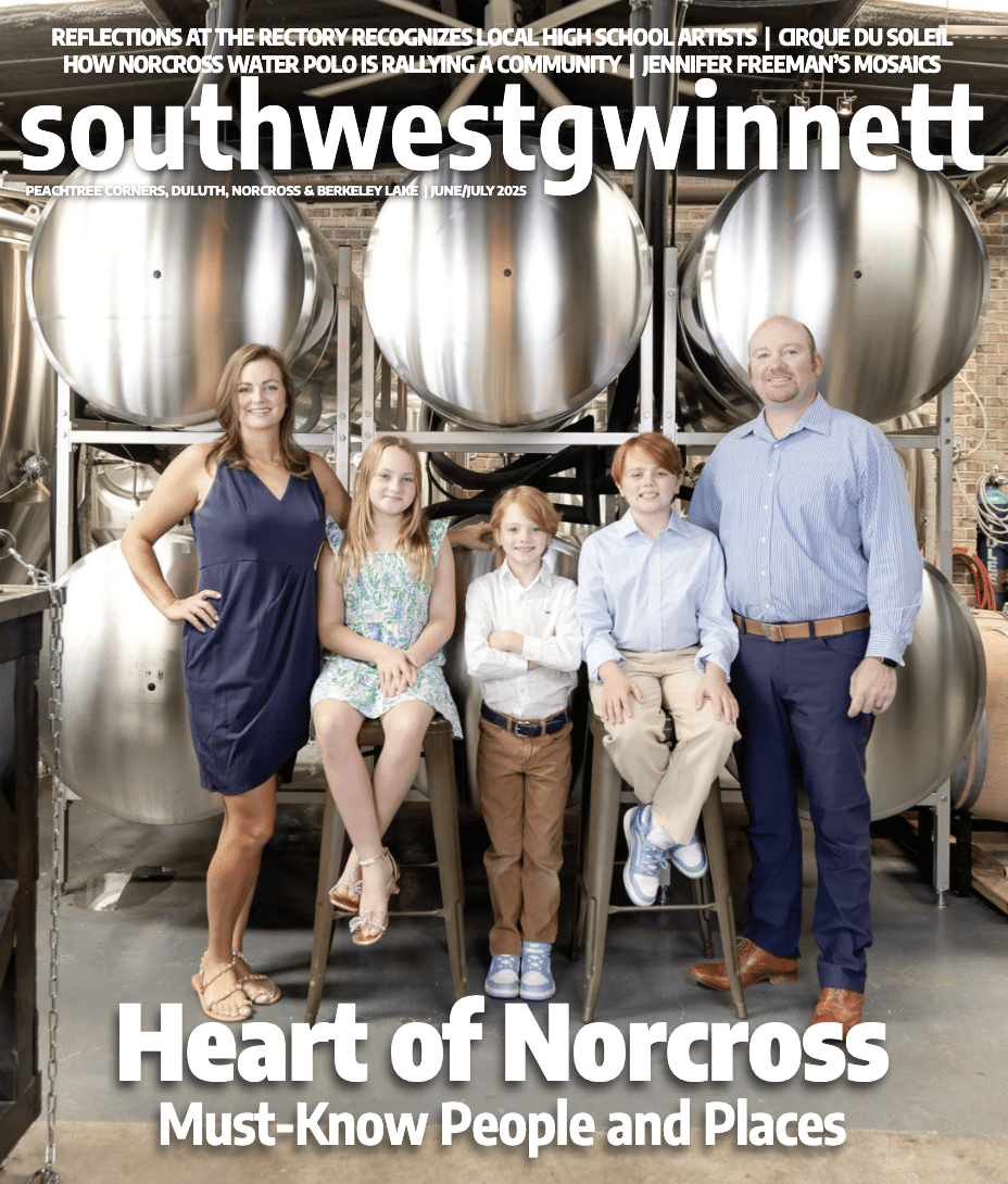 Cover of the June/July issue of Southwest Gwinnett magazine with the magazine name at the top, Heart of Norcross in white type at the bottom and a photo of a man and woman with their three kids in front of brew tanks at Cultivation Brewery.